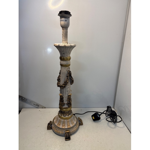 157 - Decorative carved lamp base with gold-tone details and floral accents, wired for electricity.