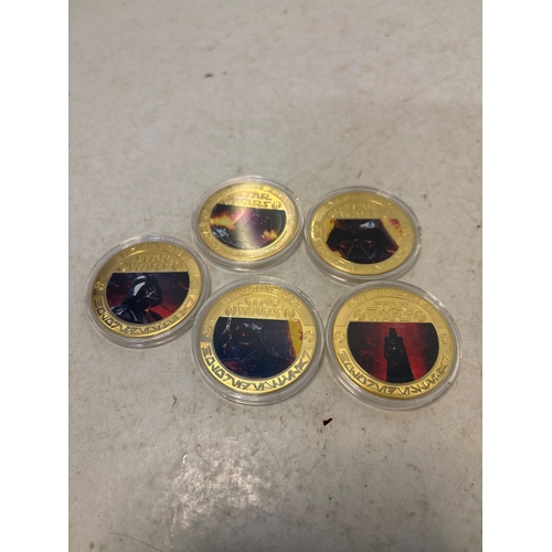 162 - Five gold-tone coins featuring printed designs with characters or scenes in protective casings. Cond... 