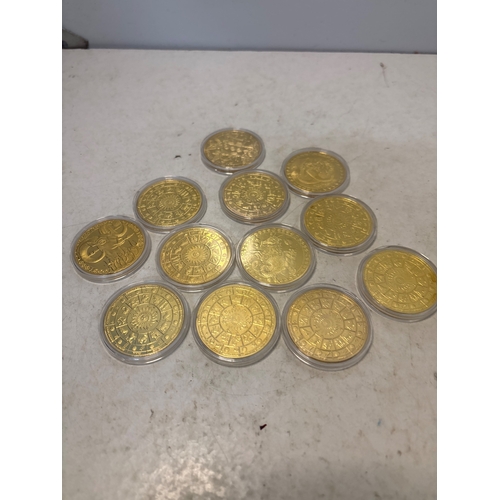 163 - Gold-colored coins in protective cases, design details not specified.