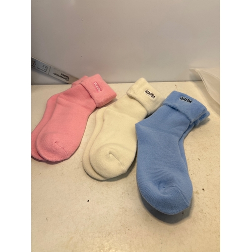 173 - Three warm socks in pink, cream, and blue, labeled 'Warm'.