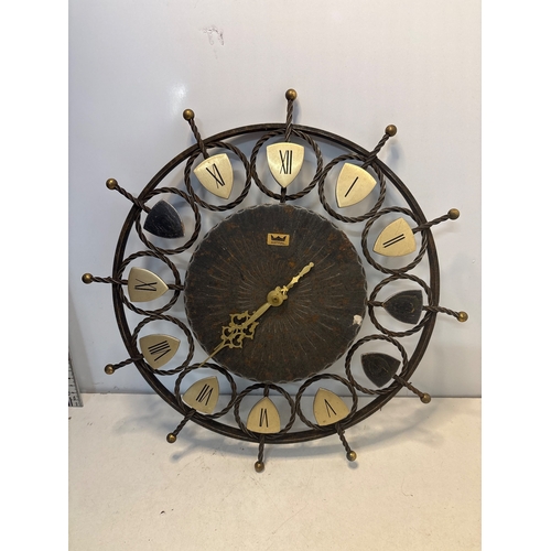 80 - Smiths Astral wall clock featuring a wrought iron frame, Roman numeral markers, and decorative hands... 