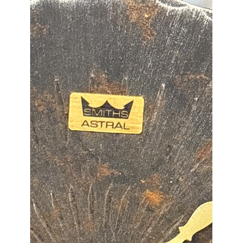 80 - Smiths Astral wall clock featuring a wrought iron frame, Roman numeral markers, and decorative hands... 