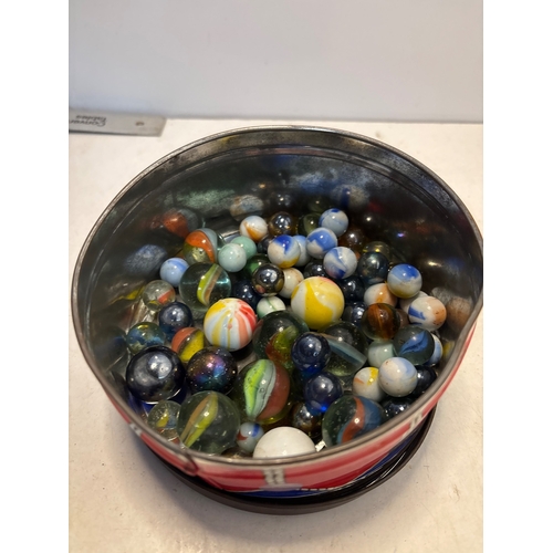 103 - Vintage-style glass marbles of various sizes, colors, patterns, and designs contained in a metallic ... 