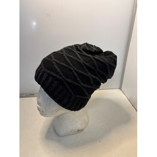 115 - Black knit beanie with diagonal ribbed pattern.