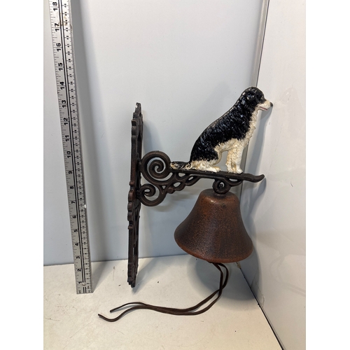 86 - Cast iron wall-mounted bell with a dog detail design.