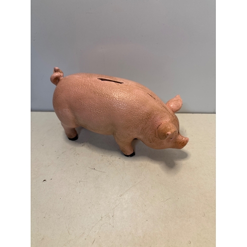 90 - Cast iron pig-shaped coin bank with pink paint and coin slot.
