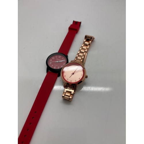 97 - Two wristwatches, one with a red strap and one rose gold.