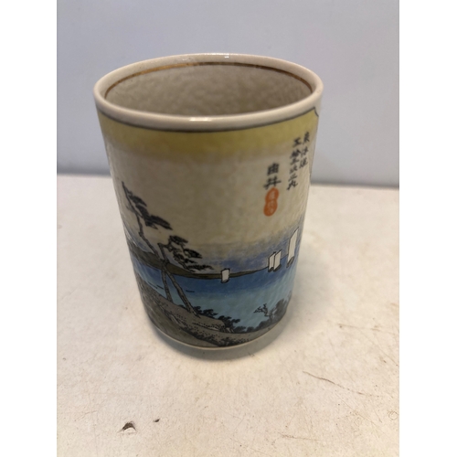 19 - Hand-painted Japanese ceramic cup featuring landscape design and kanji mark on the base.