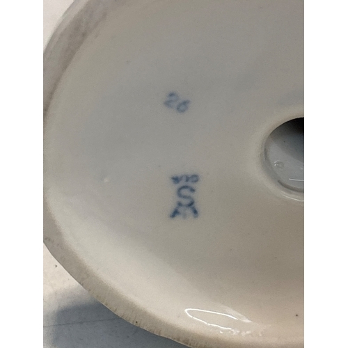 25 - Porcelain figurine of a blacksmith at an anvil, marked '26' and '202' on the base, in good condition... 