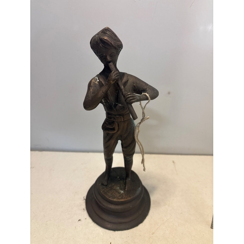27 - Bronze figurine depicting a flute player with detailed features, standing on a round pedestal base. ... 