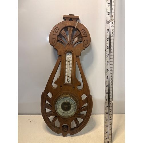 35 - Ornate wooden barometer and thermometer combo, featuring intricate carving and a vintage aesthetic, ... 