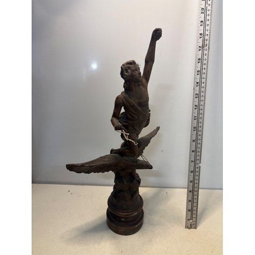 36 - Spelterfigure of a man on an eagle base. Approximately 12 inches tall, showing intricate detailing a... 