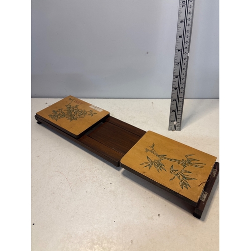 37 - Expandable wooden book holder with engraved floral designs.