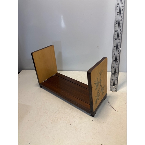 37 - Expandable wooden book holder with engraved floral designs.