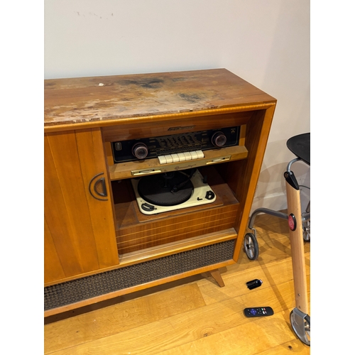 47 - Mid-century wood cabinet with built-in radio and record player.