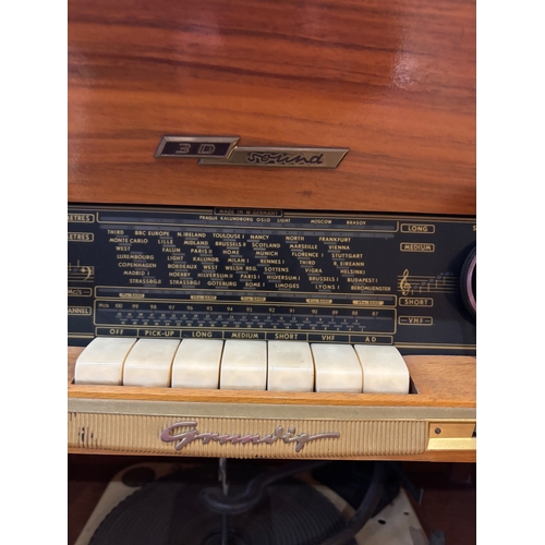 47 - Mid-century wood cabinet with built-in radio and record player.