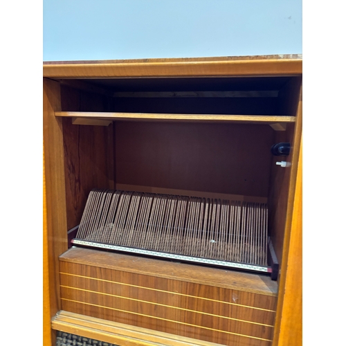 47 - Mid-century wood cabinet with built-in radio and record player.