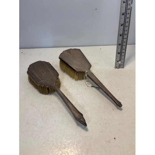 49 - Two hallmark silver  vanity brushes with bristles intact.