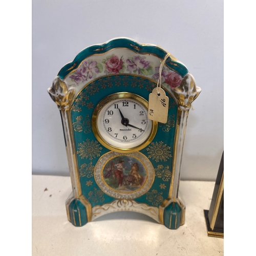 5 - Four assorted table clocks, including ceramic, metal, and stone pieces with decorative elements and ... 