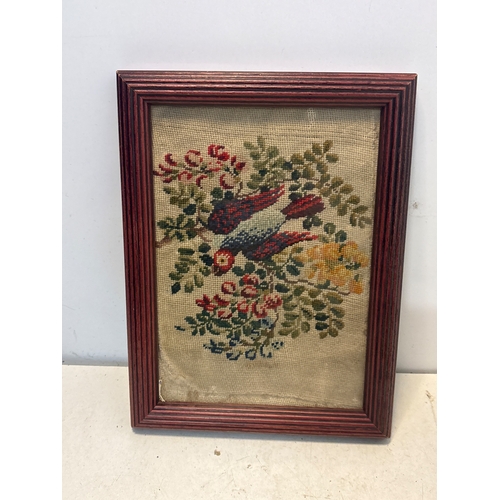 51 - Framed needlepoint depicting a colorful bird and floral scene. Housed in a wooden frame. Condition s... 