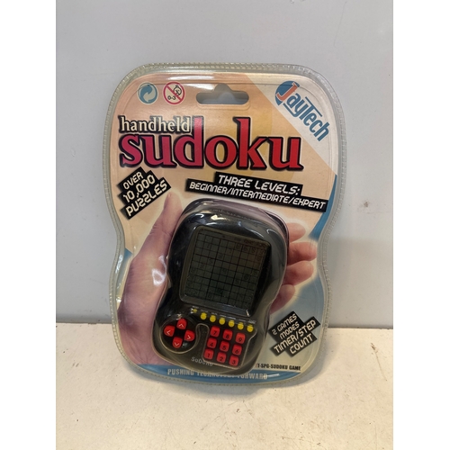 52 - JayTech Handheld Sudoku with over 10,000 puzzles, featuring three levels: Beginner, Intermediate, an... 
