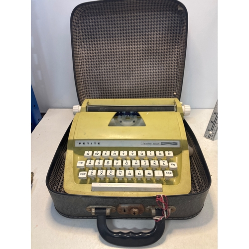 53 - Petite manual typewriter in yellow with carrying case.