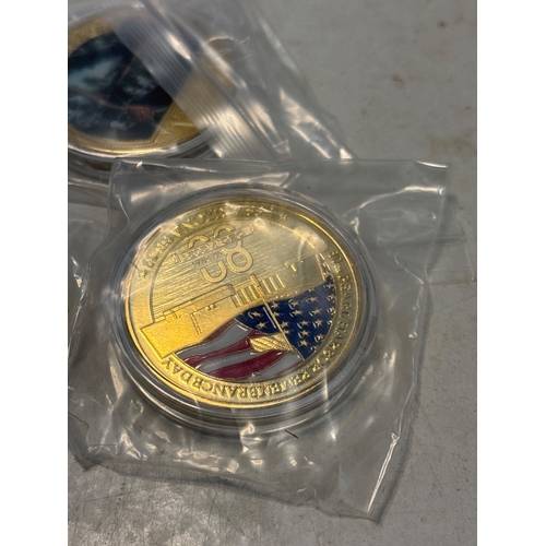 82 - Five gold-toned commemorative coins, each encased in a protective plastic pouch, featuring various d... 