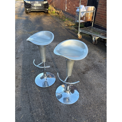 111 - Two silver bar stools with chrome bases, featuring adjustable height and footrests. Good condition n... 