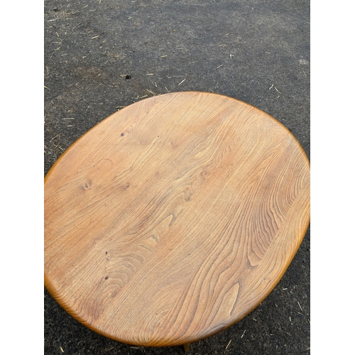112 - Ercol wooden oval coffee table with spindle shelf design.