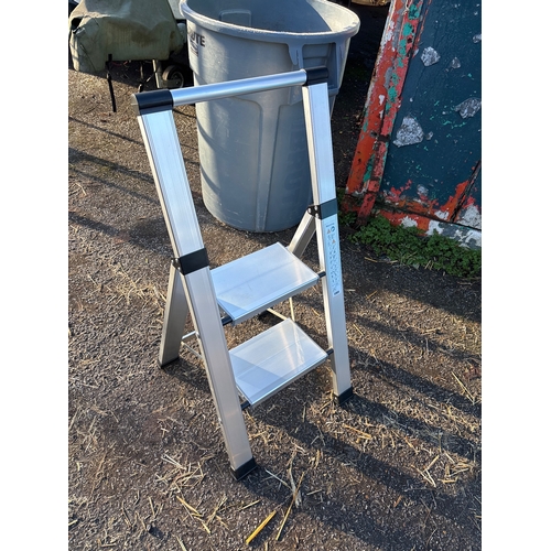 115 - Two-step aluminum ladder with compact foldable design not postable.