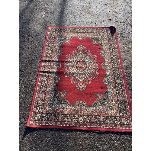 116 - A red Persian-style rug with floral patterns, approx. 5x8 ft.