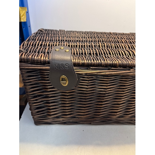 124 - Marks and Spencer wicker hamper with leather straps and metal closures.
