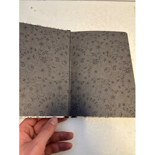 139 - Hardcover notebook with floral motif, black spine, and blank lined pages.