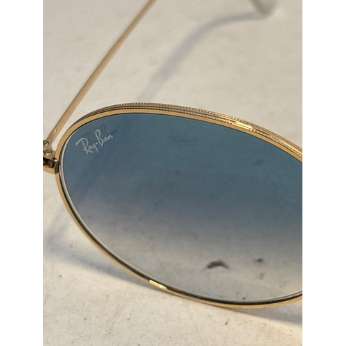 155 - Ray-Ban oval sunglasses with gold-tone frames, blue gradient lenses, and size 54?21. Marked on insid... 