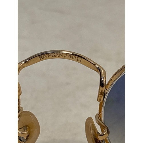 155 - Ray-Ban oval sunglasses with gold-tone frames, blue gradient lenses, and size 54?21. Marked on insid... 