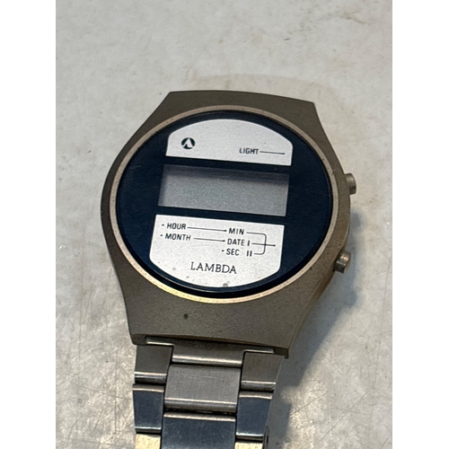 94 - Lambda digital wristwatch with metal strap and blue face.