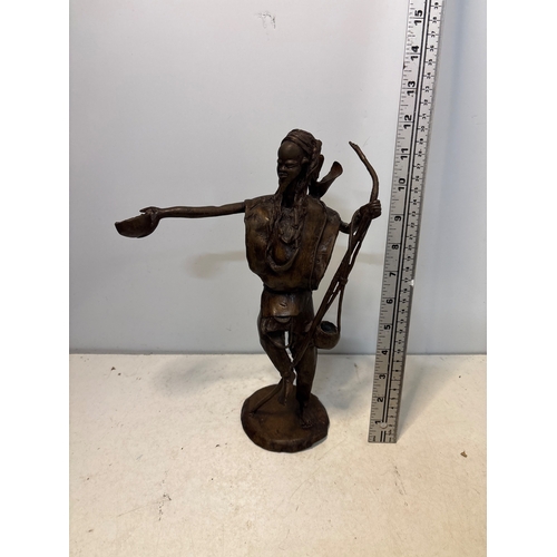 184 - Bronze sculpture of a figure with arm extension and details.