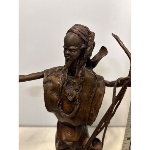 184 - Bronze sculpture of a figure with arm extension and details.