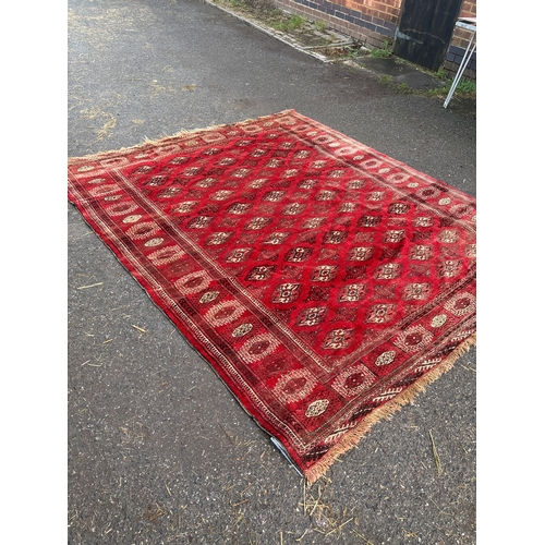 187 - Handmade Turkmen rug, red with geometric motifs, 233x204 cm.
