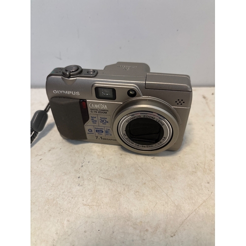 195 - Olympus Camedia digital camera with 7.1 MP resolution.