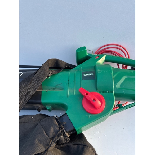 196 - Green electric leaf blower with black bag and red cord not postable.