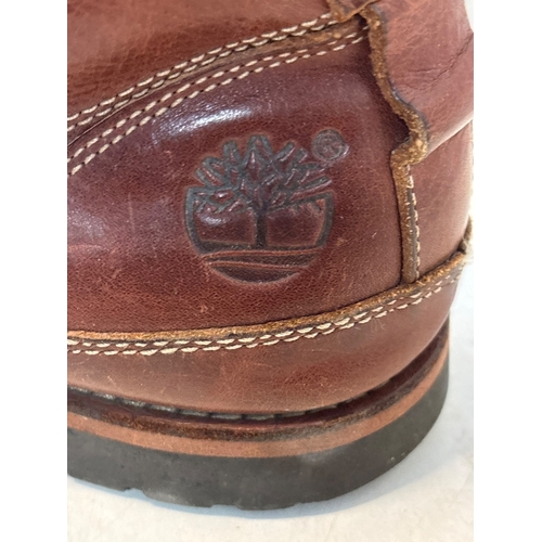 199 - Brown leather Timberland boots with lace-up design. Features embossed Timberland tree logo. Shows si... 