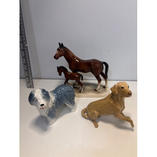 18 - Ceramic animal figurines including a horse with foal, a sheepdog, and a Labrador retriever. Good con... 