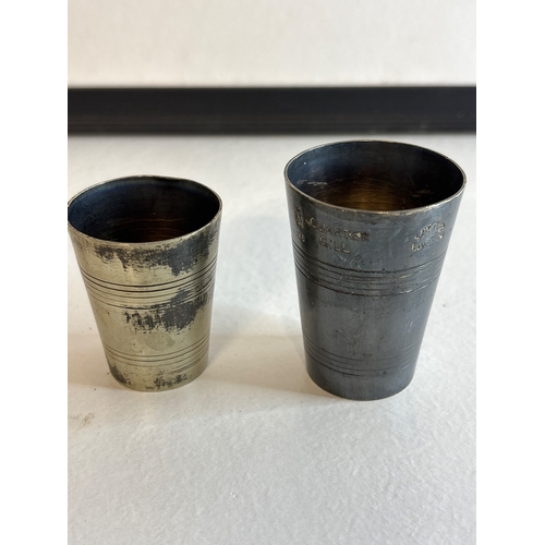 10 - Two small silver plated spirit measures with engraved markings.