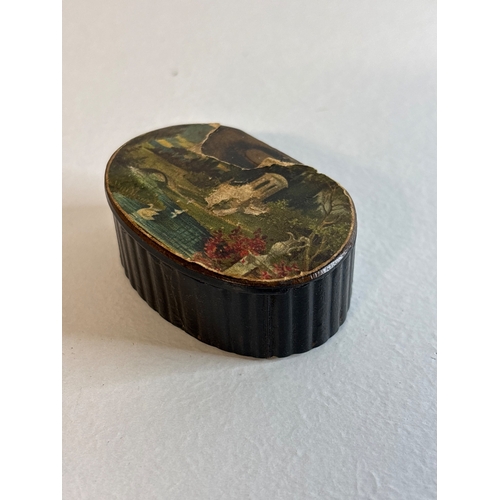 17 - Small oval black snuff box with hinged lid and pastoral scene a/f