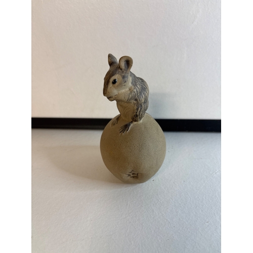 24 - Ceramic poole figurine of a mouse atop a textured sphere.