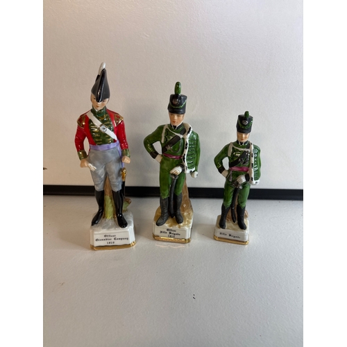 27 - Three porcelain soldier figurines in uniform.