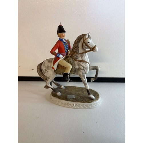 34 - Porcelain figure of mounted man in uniform, multi-color.
