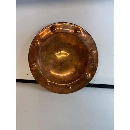 43 - Hand-hammered copper plate with raised rim details.
