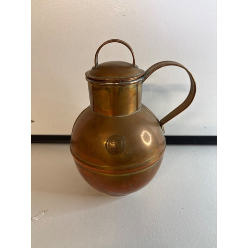 44 - Copper pitcher with embossed crest and handle.
